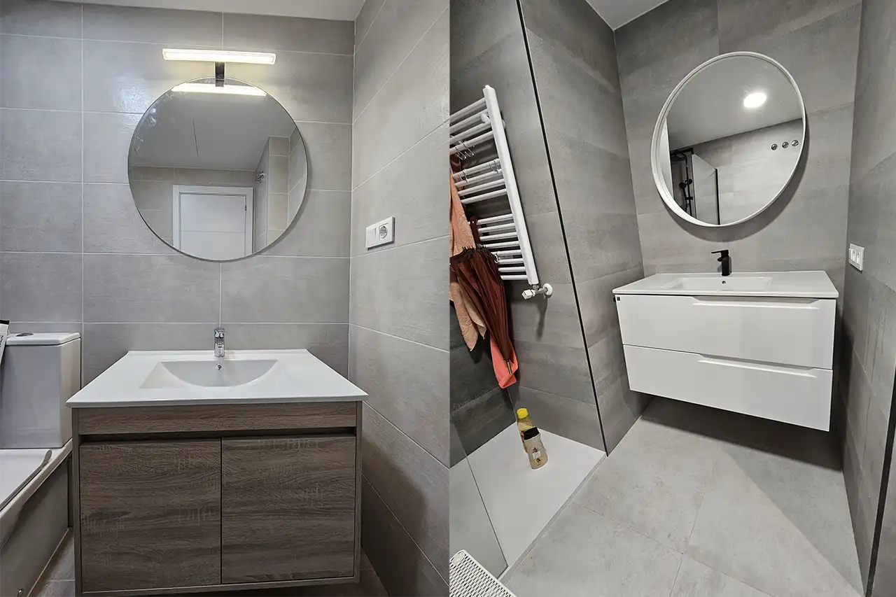 Baño moderno con paredes grises, lavabo blanco suspendido, espejo redondo y grifería negra.